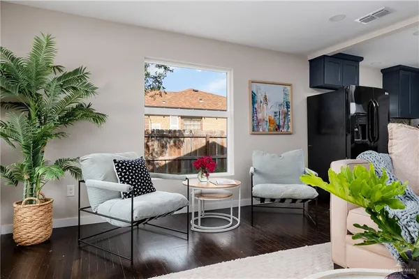a living room with furniture and a potted plant