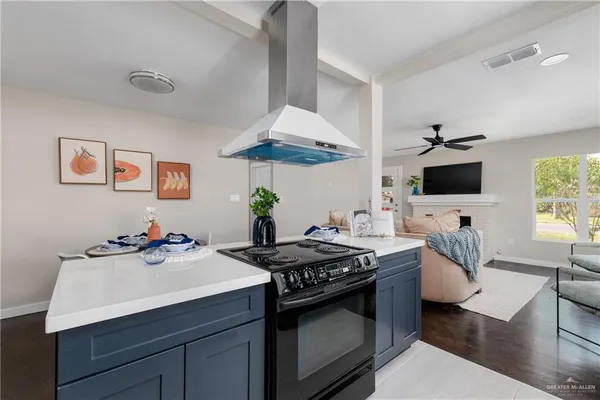 a kitchen with a sink stove and microwave