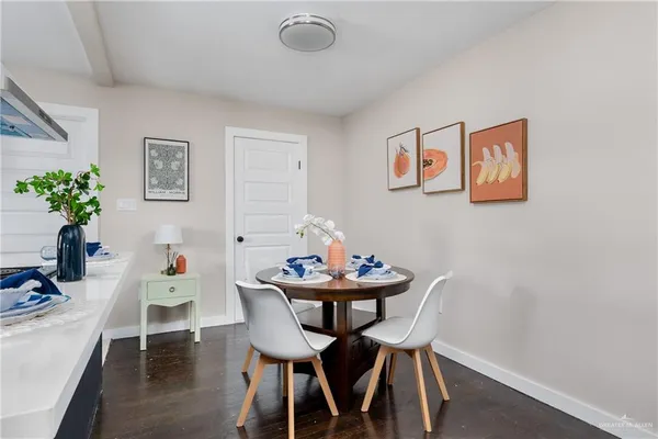 a dining room with furniture and wooden floor