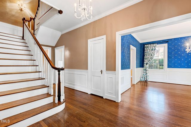 a view of an entryway with wooden floor and staircase
