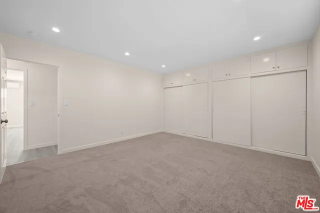 a view of a park with plants and a car parked