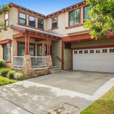 a front view of a house with a yard and a garage