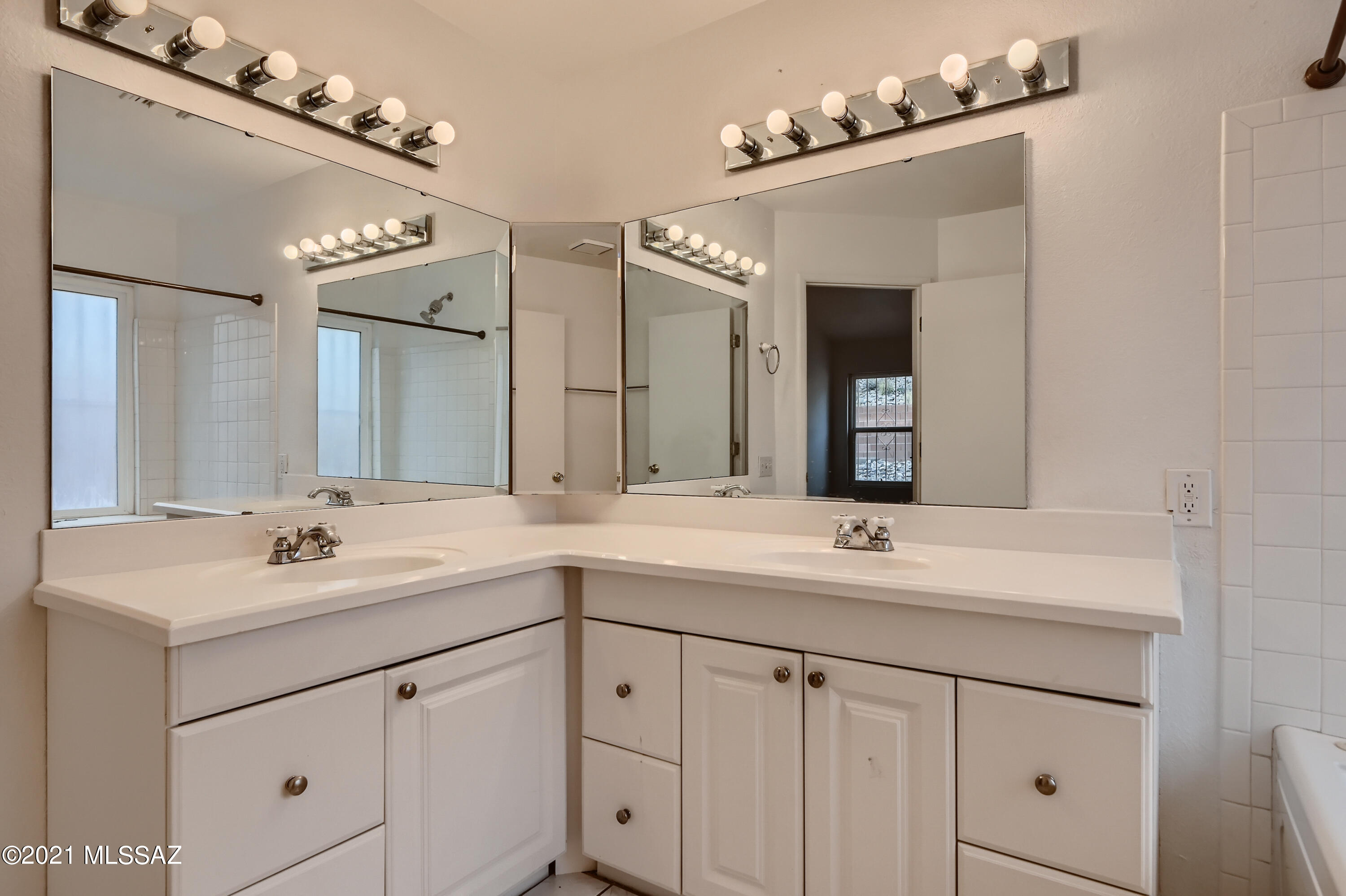 10681 Keystone Road East Tucson, AZ 85730 - Photo 19 of 33 a bathroom with a sink vanity and a mirror