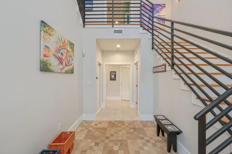 a living room with furniture kitchen view and a large window