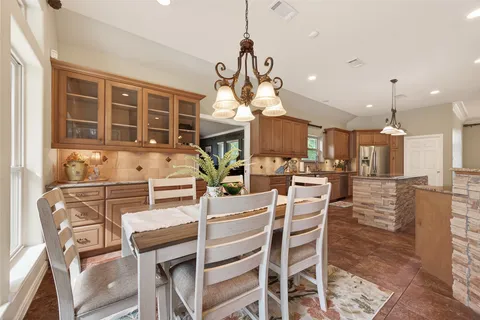 a dining room with a table and chairs
