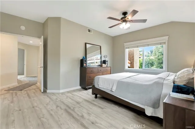 a bedroom with a bed and a ceiling fan