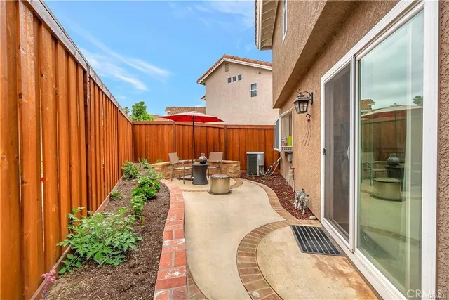 a view of a patio with couches table and chairs and potted plants