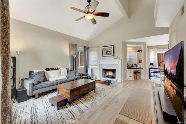 a living room with furniture fireplace and flat screen tv
