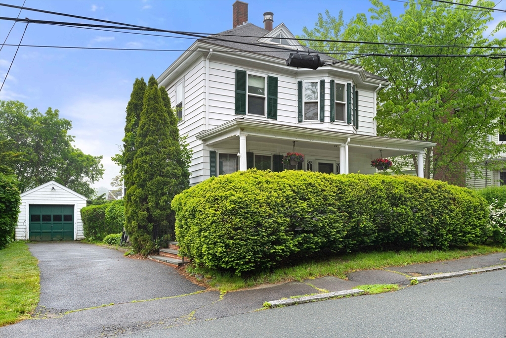 a front view of a house with a garden