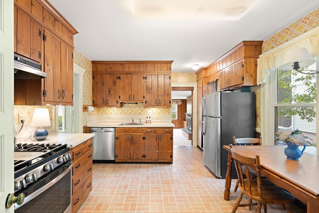 4 Prince Street Marblehead, MA 01945 - Photo 11 of 27 a kitchen with stainless steel appliances granite countertop a stove refrigerator sink and cabinets