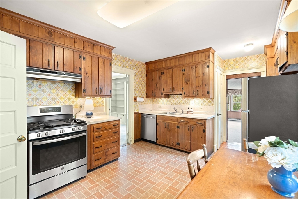 4 Prince Street Marblehead, MA 01945 - Photo 12 of 27 a kitchen with a stove a sink and a refrigerator