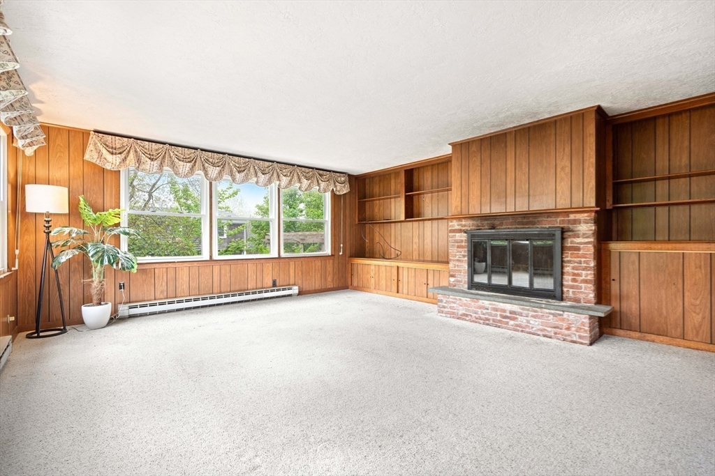 4 Prince Street Marblehead, MA 01945 - Photo 15 of 27 an empty room with floor to ceiling window and fireplace