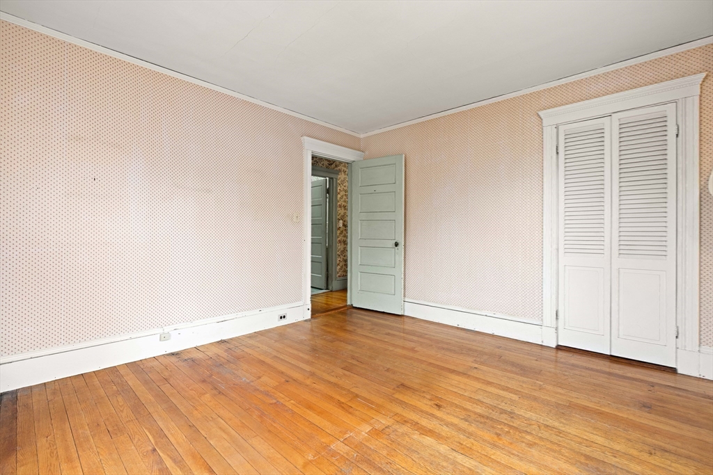4 Prince Street Marblehead, MA 01945 - Photo 19 of 27 an empty room with wooden floor and windows