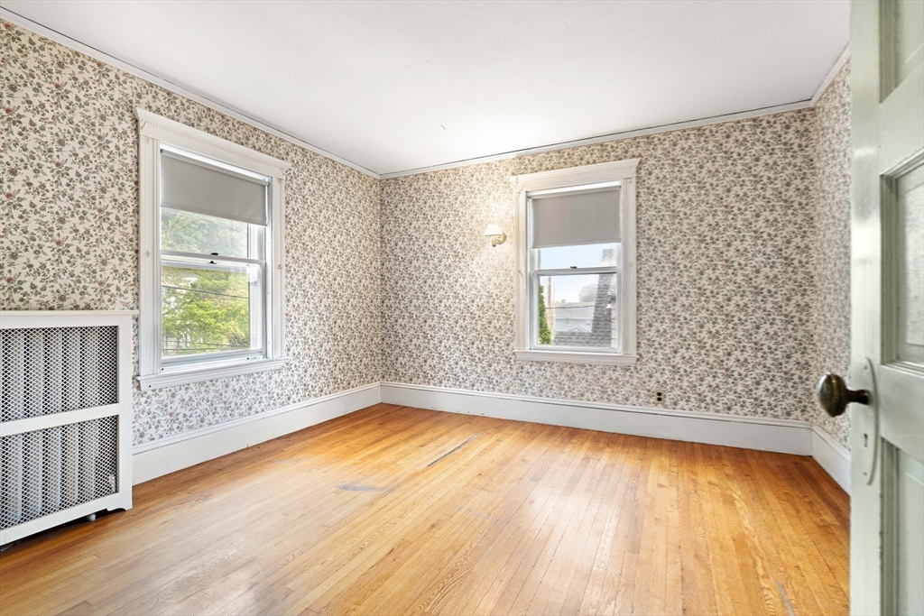 4 Prince Street Marblehead, MA 01945 - Photo 21 of 27 a view of an empty room with wooden floor and a window