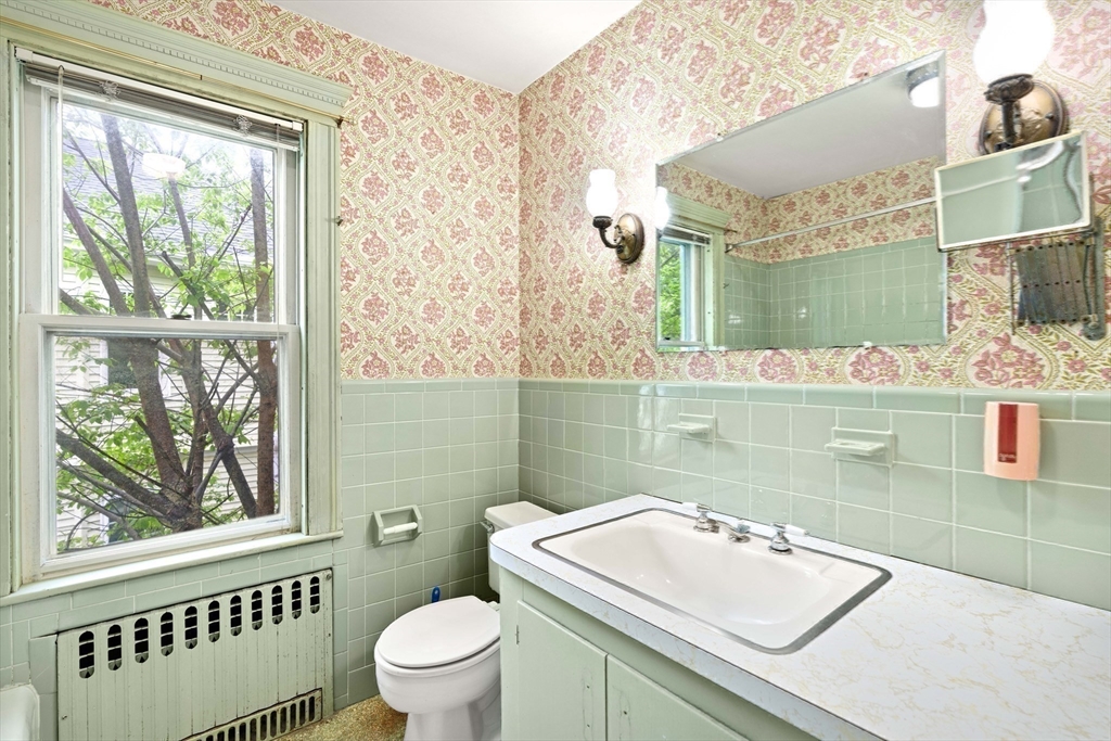 4 Prince Street Marblehead, MA 01945 - Photo 22 of 27 a bathroom with a sink toilet vanity and window