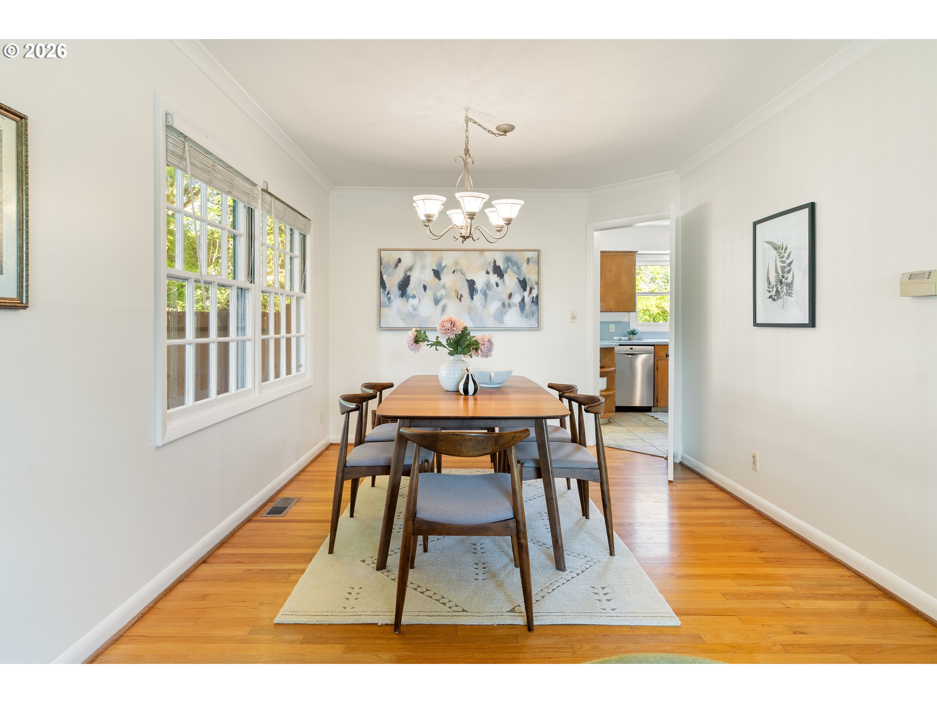 7541 Northeast Alameda Street Portland, OR 97213 - Photo 7 of 35 a dining room with wooden floor a chandelier a wooden table and chairs