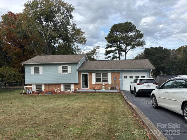 a view of a house with a big yard and swimming pool