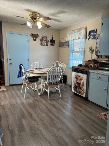 a dining room with furniture and wooden floor