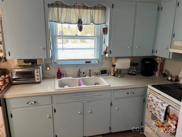 a kitchen with appliances cabinets and a window