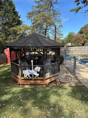 a view of a house with backyard outdoor seating and hardwood