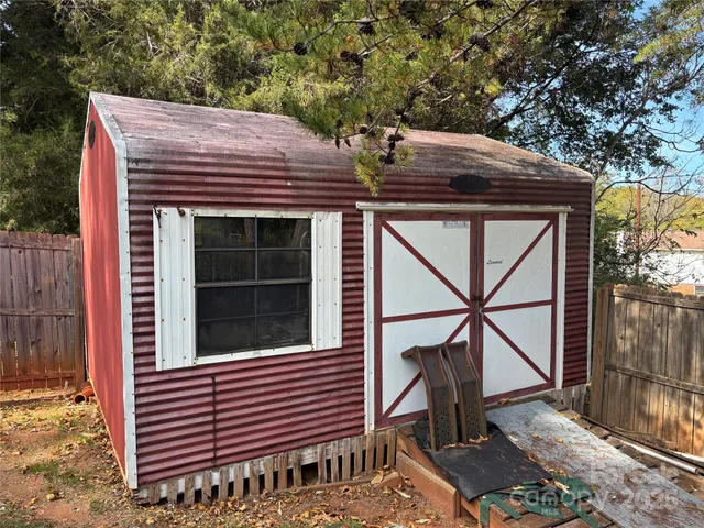 a view of a house with a door and wooden deck