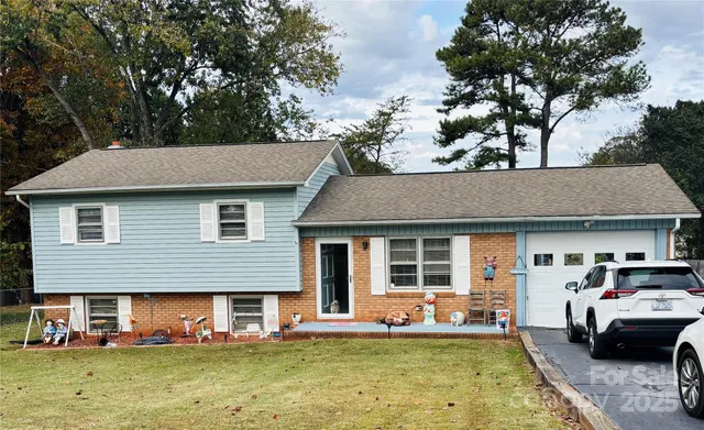 a front view of a house with a garden and swimming pool