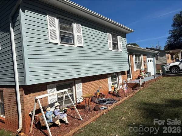 a view of a car park in front of a house