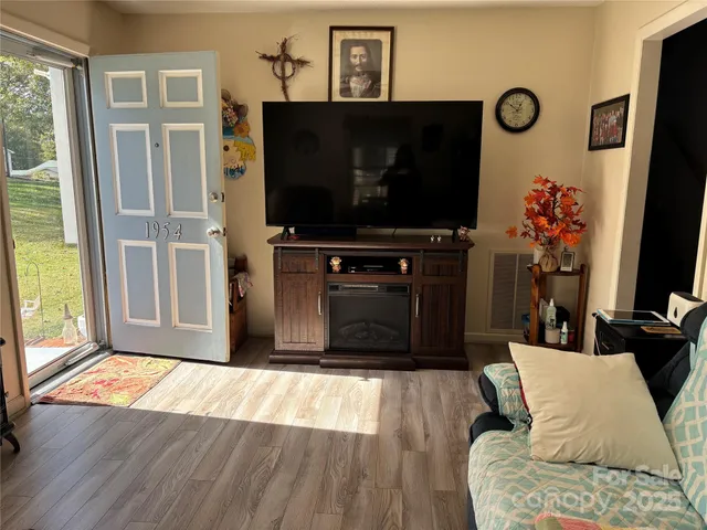 a living room with furniture and a flat screen tv