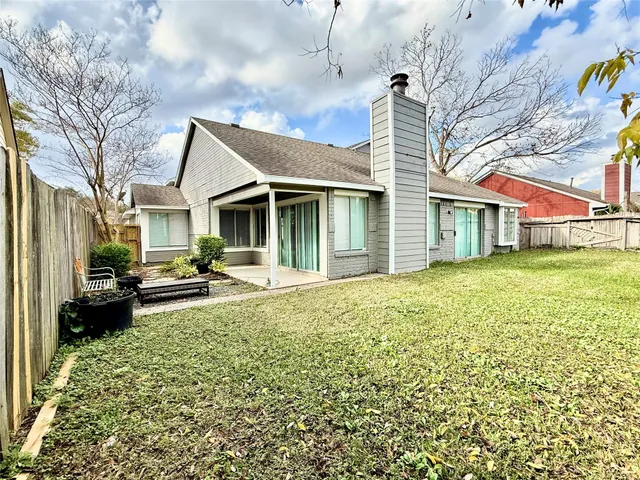 a front view of a house with a garden and patio