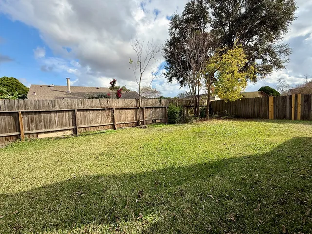 a view of a garden with large trees