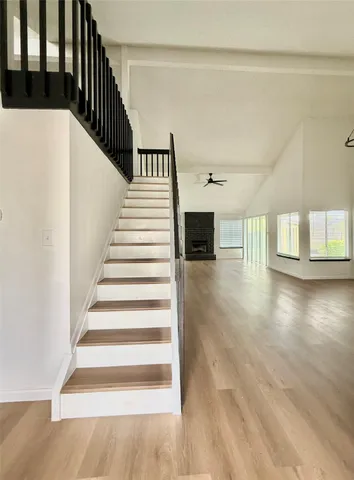 a view of entryway and hall with wooden floor