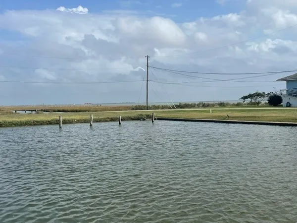 a view of a lake with a table and chairs