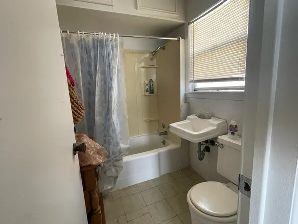 a view of a room with furniture and a window