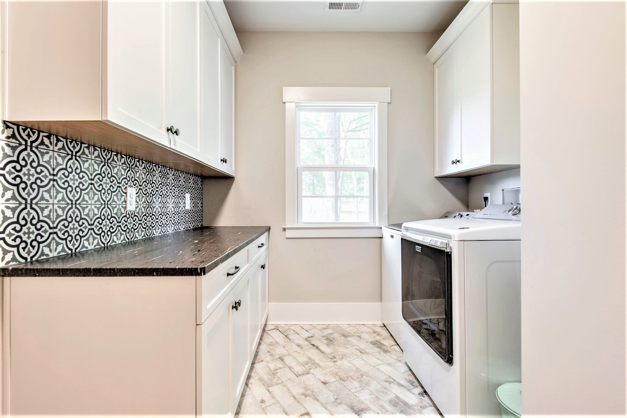 1387 Camp Ravine Road Burns, TN 37029 - Photo 27 of 49 a kitchen with granite countertop a sink stove and cabinets