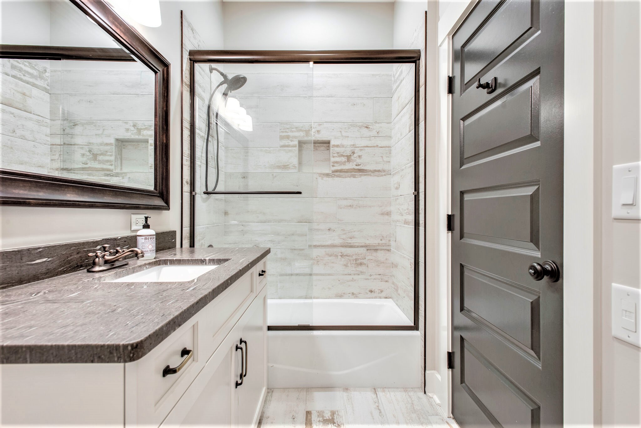 1387 Camp Ravine Road Burns, TN 37029 - Photo 31 of 49 a bathroom with a granite countertop shower mirror and a sink