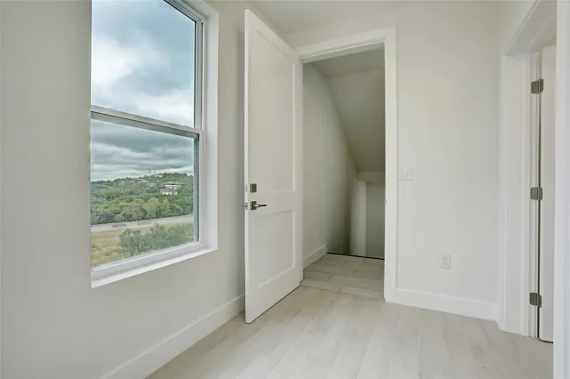 a view of a room with a sink and cabinets
