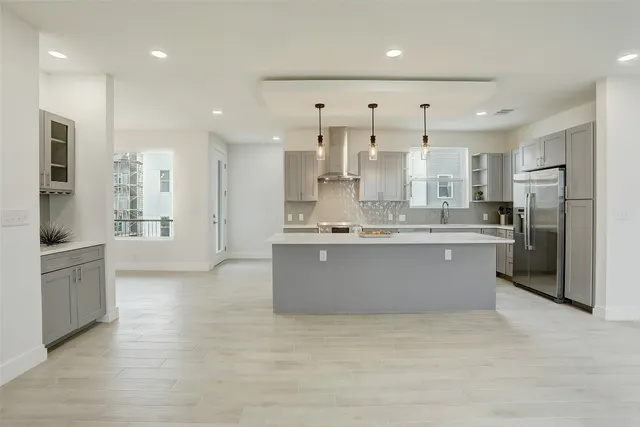 a large kitchen with cabinets and a stainless steel appliances