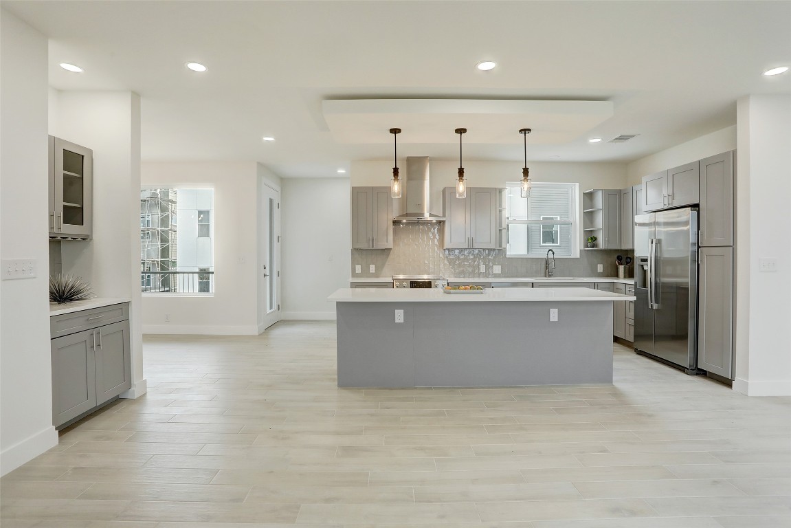 4300 Mansfield Dam Road, Unit 1321 /1331 Austin, TX 78734 - Photo 8 of 31 a large kitchen with stainless steel appliances kitchen island a large counter top and wooden floors
