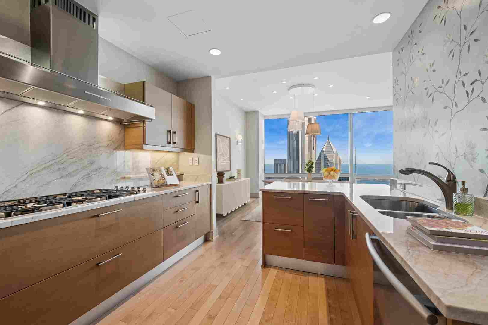401 North Wabash Avenue, Unit 57F Chicago, IL 60611 - Photo 7 of 45 a kitchen with stainless steel appliances granite countertop a sink stove and refrigerator