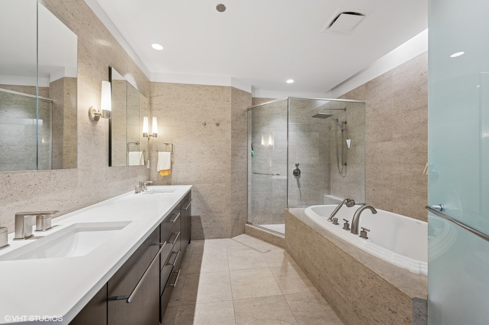 401 North Wabash Avenue, Unit 57F Chicago, IL 60611 - Photo 10 of 45 a bathroom with a bathtub double vanity sink and a shower