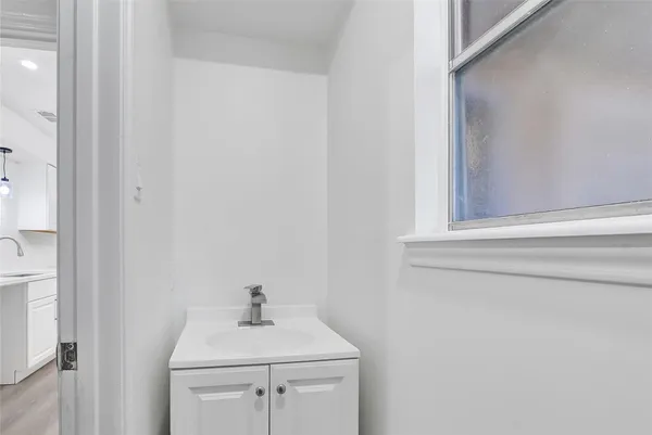 a bathroom with a sink a toilet and mirror