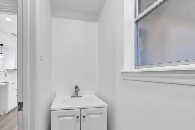a bathroom with a sink a toilet and mirror