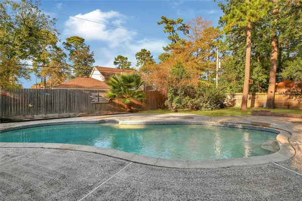 a view of a swimming pool with a yard