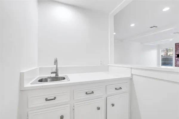a kitchen with a sink and cabinets