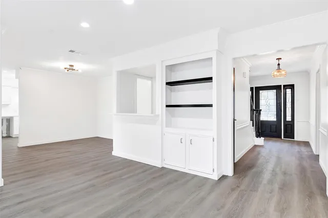 an empty room with wooden floor