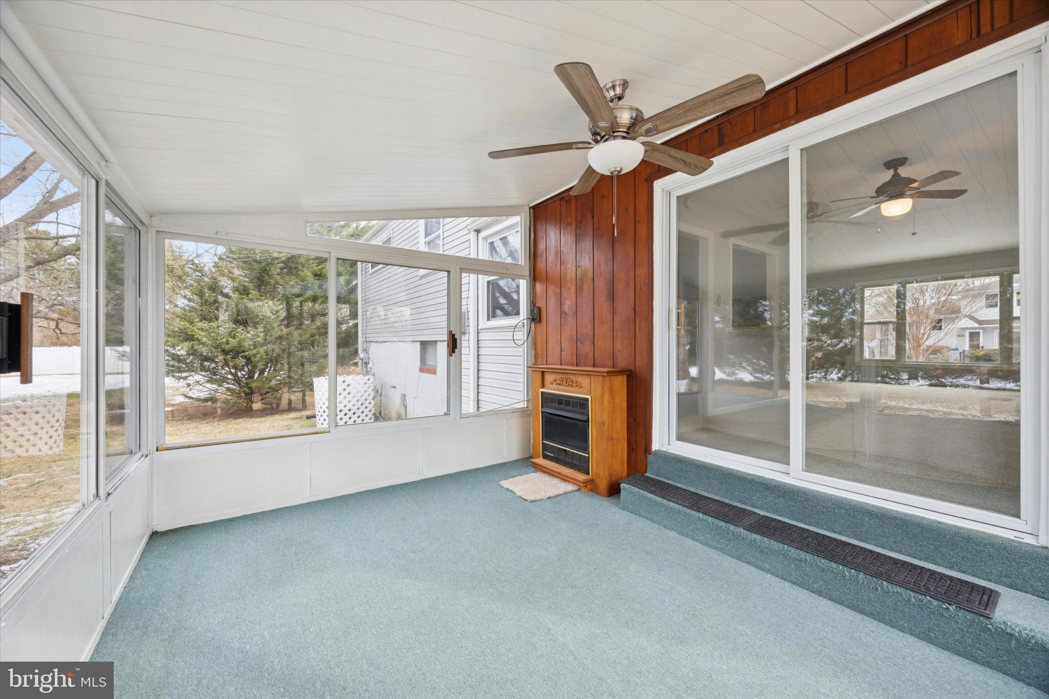 713 Scott Lane Wallingford, PA 19086 - Photo 14 of 34 Bright and airy sunroom with gas fireplace.