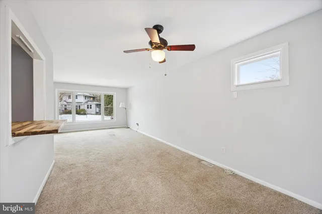a view of livingroom with hardwood floor and a ceiling fan