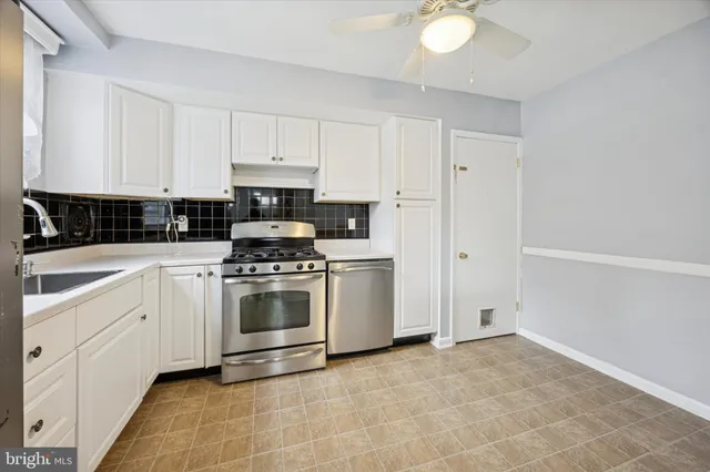 a kitchen with cabinets a stove and a refrigerator