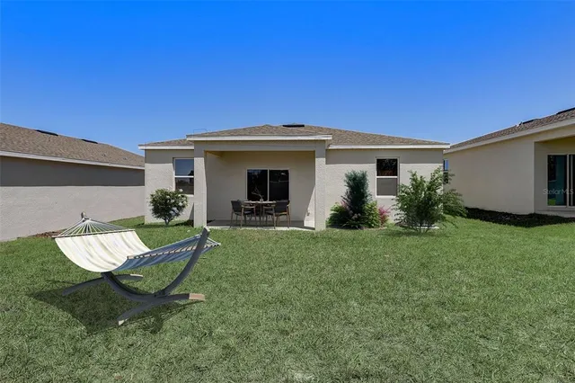 a view of a backyard with plants and a patio