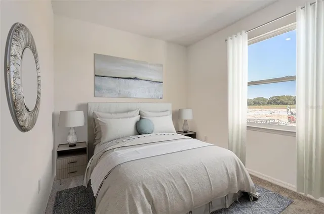 a bed sitting in a bedroom next to a window